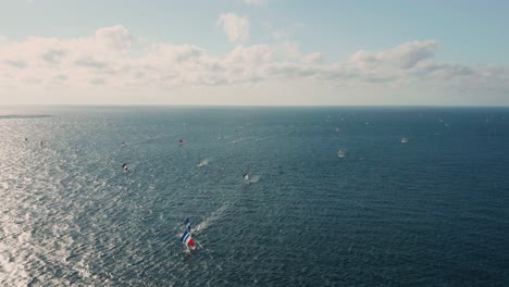 Jukung-fishing-boats-with-crab-claw-sails-return-from-voyage-at-blue-sea