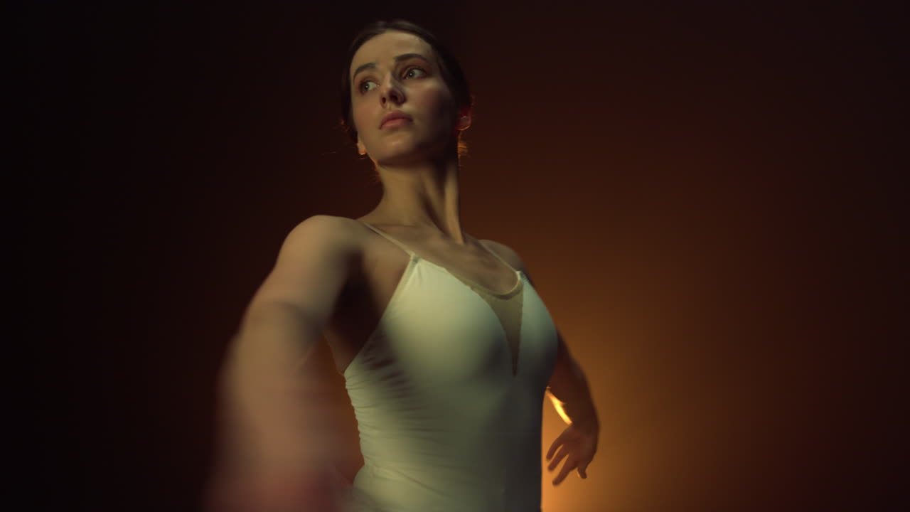 Sensual dancer spinning around indoors. Ballerina performing circular movements