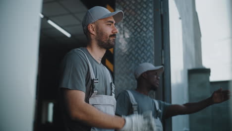 two workers in uniforms at a loading dock