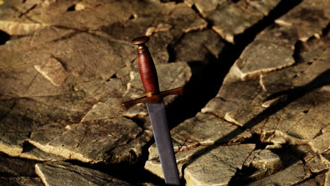 excalibur sword in rocky stone at sunset