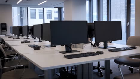 empty modern computer lab with multiple workstations