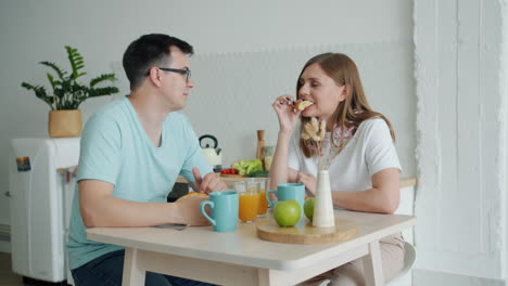 couple enjoying breakfast in modern kitchen