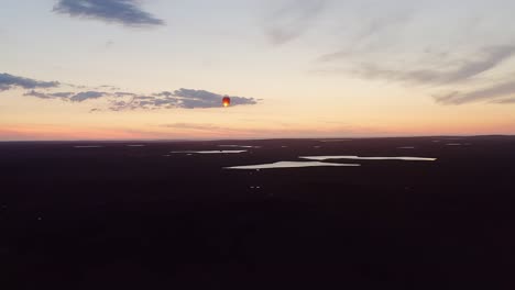 Close-up-drone-shot-of-a-sky-lantern-rising-over-lochs-on-the-Hebrides