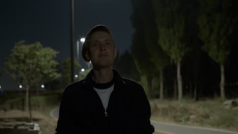 white-caucasian-male-man-model-shows-like-good-class-gesture-with-his-hand-in-the-night-park-outdoors