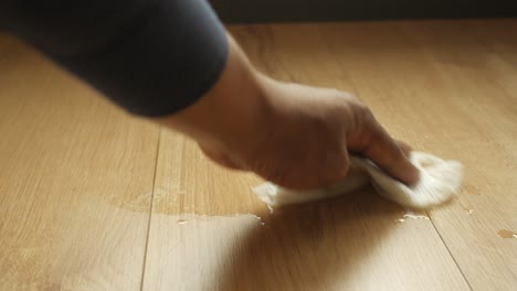 cleaning up a water spill on a wooden floor