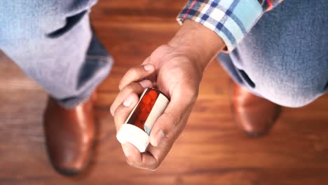 person holding a bottle of pills