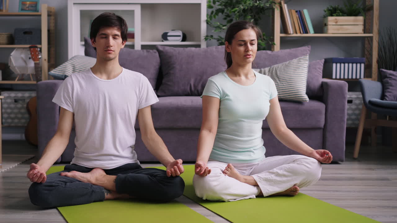 Couple Practicing Meditation and Yoga at Home