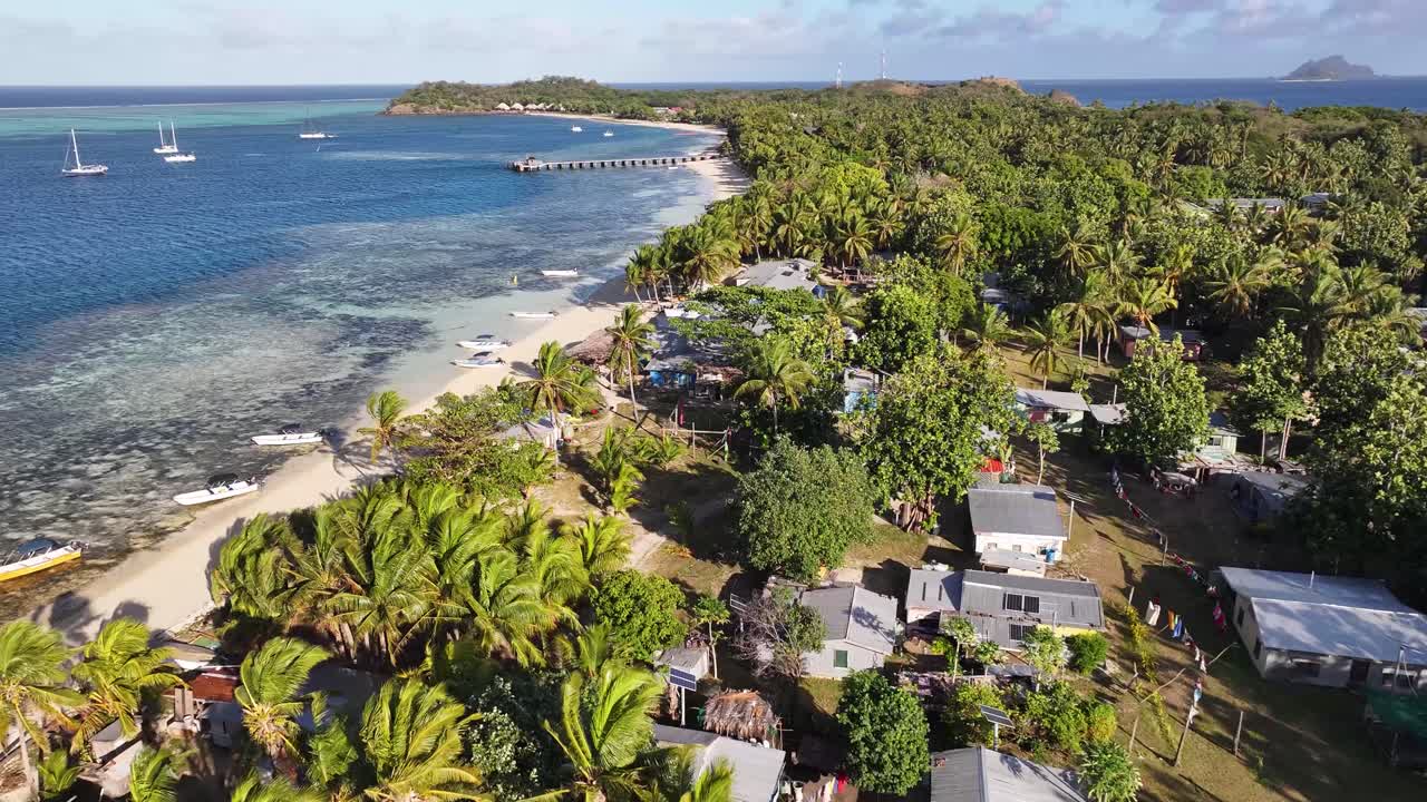 Traditional Boats At The Coastal Town Village On Mana Island, Mamanuca Islands, Fiji. Aerial Drone Shot