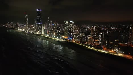 totally breathtaking views, drone flying high out at sea capturing surfers paradise nightscape of glistening water and sparkling highrise lights
