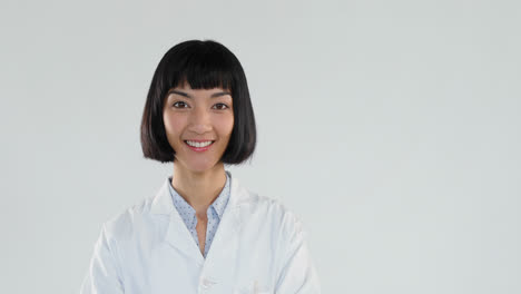 female doctor standing with arms crossed against white background 4k 4k