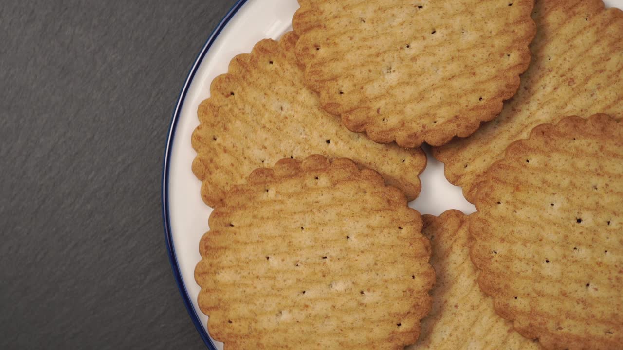Golden round cookies on a white plate