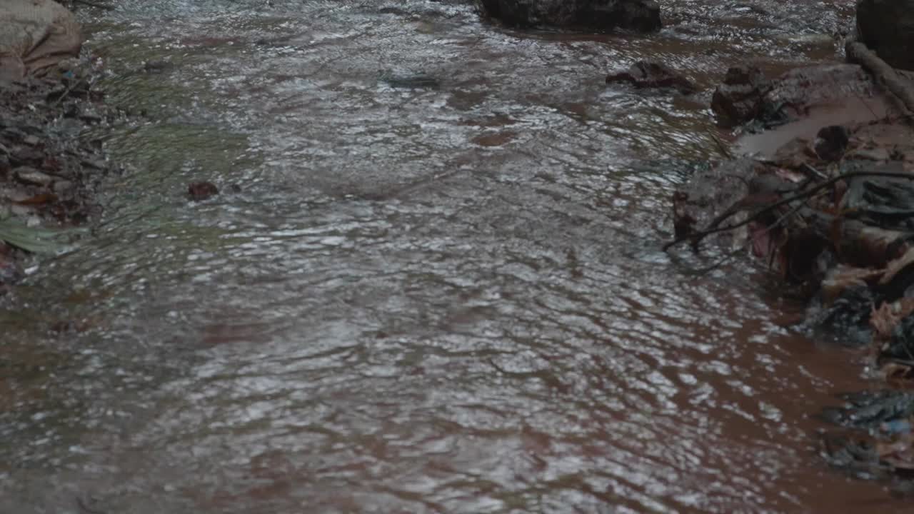 Stream water flowing on a rocky ground