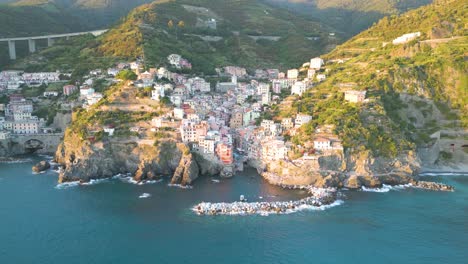 incredible establishing shot of cinque terre village at sunset