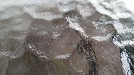glass table top with fine scratches and bumpy textured pattern surface slow motion moving footage