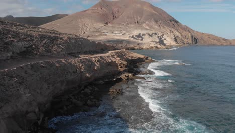 Aerial-forward-over-Porto-dos-Frades-coast-on-Porto-Santo-island,-Madeira