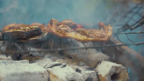 fat dripping off steak cooking on barbeque over hot charcoals