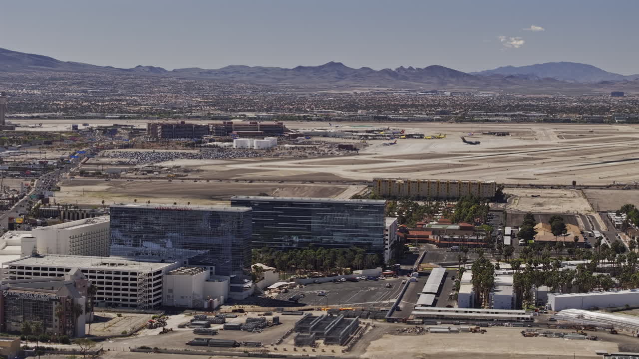 Las Vegas Nevada Aerial v78 zoomed low flyover the neighborhood suburbs capturing airplane taking off from the airport runway and mountains on the skyline - Shot with Mavic 3 Pro Cine - Apr 30th 2024
