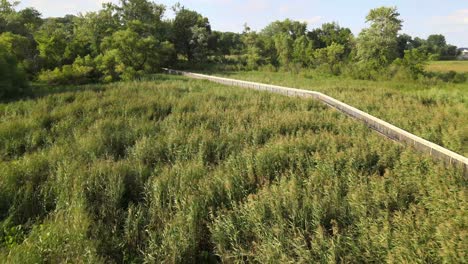 Drone-flying-along-the-walking-path-in-Old-Cedar-Avenue,-Bloomington-Minnesota