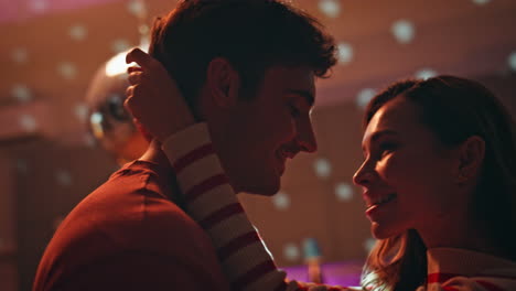 sensual couple moving together at disco ball lights close up. woman hugging man