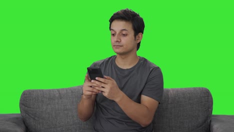 Indian-man-chatting-with-someone-Green-screen