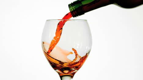 red wine pouring into glass