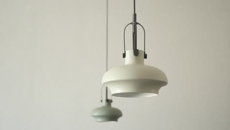 Gray-ceiling-lamp-hanging-in-a-room