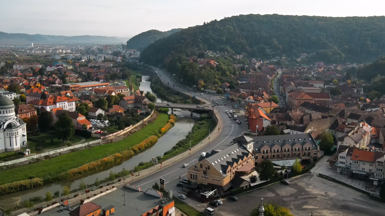 Aerial drone view of the Historic Centre of Sighisoara, Romania. Old buildings, narrow streets, City Hall, river