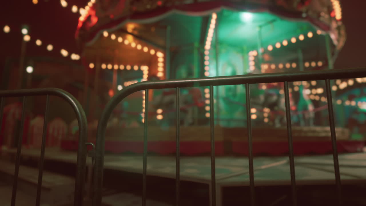 A Blurred Image Of A Lit Up Carousel At Night