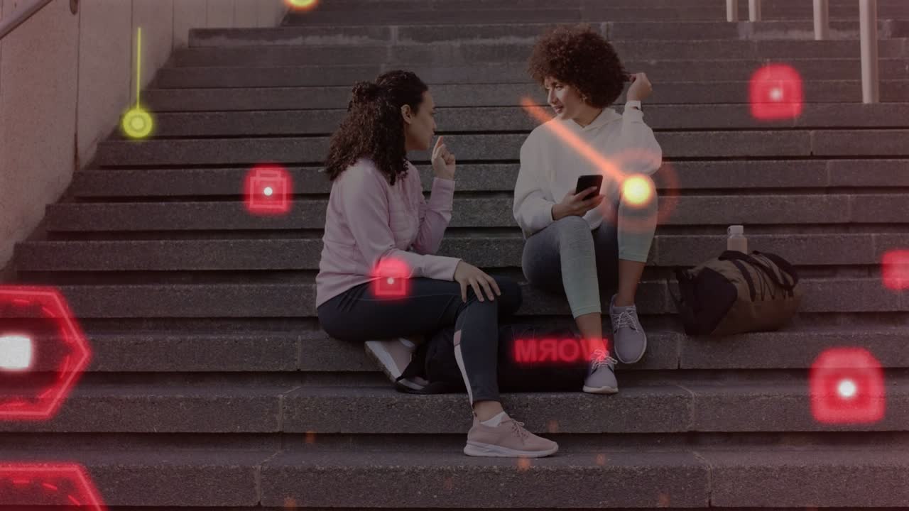 Left woman raising finger starting tech HUD sharing, right woman checking phone, red hex drifting