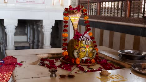 hindu god shivalinga decorated with flower offerings at temple