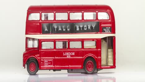 a red double-decker bus with the text a tall story stop motion film loop