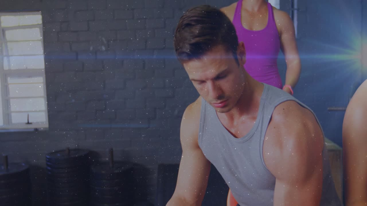 Seated man gripping hex dumbbell, curling on box while spotting, lens-flare highlighting fitness