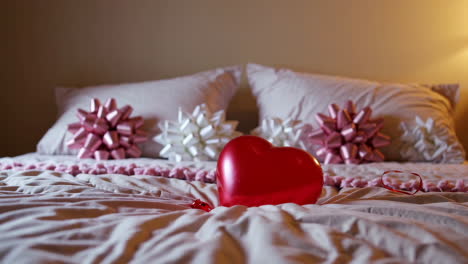 romantic bedroom decor with red heart balloon and bows