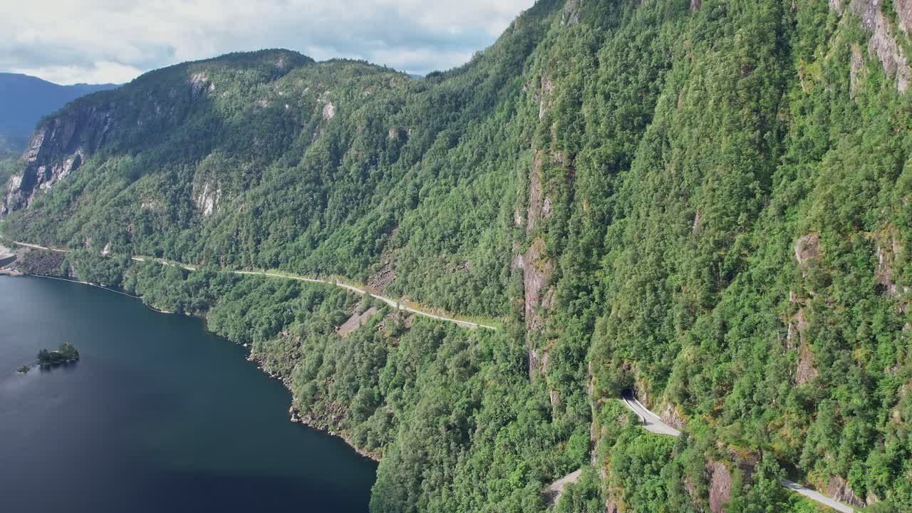 Scenic drone view of Norway's lush landscape along a tranquil fjord
