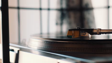 dropping the needle of a record player on vinyl to play music