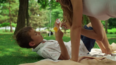 mother playing with daughter and son in the park