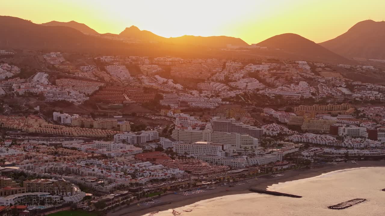 Golden sunlight rises over Costa Adeje and Los Cristianos, Tenerife’s coast, 4k