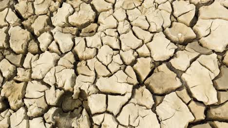 close forward motion over cracked dry soil during drought, bangladesh