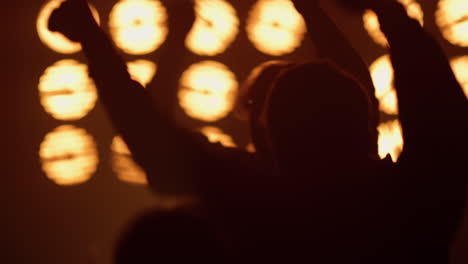 partying crowd dancing rock concert in spotlights. excited people jumping up.