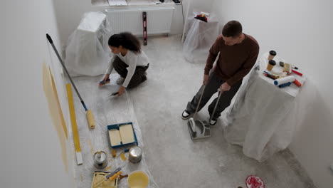 young couple painting and renovating their room