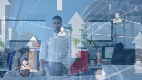 animation of upward arrows and network of people icons over two diverse colleagues talking in office