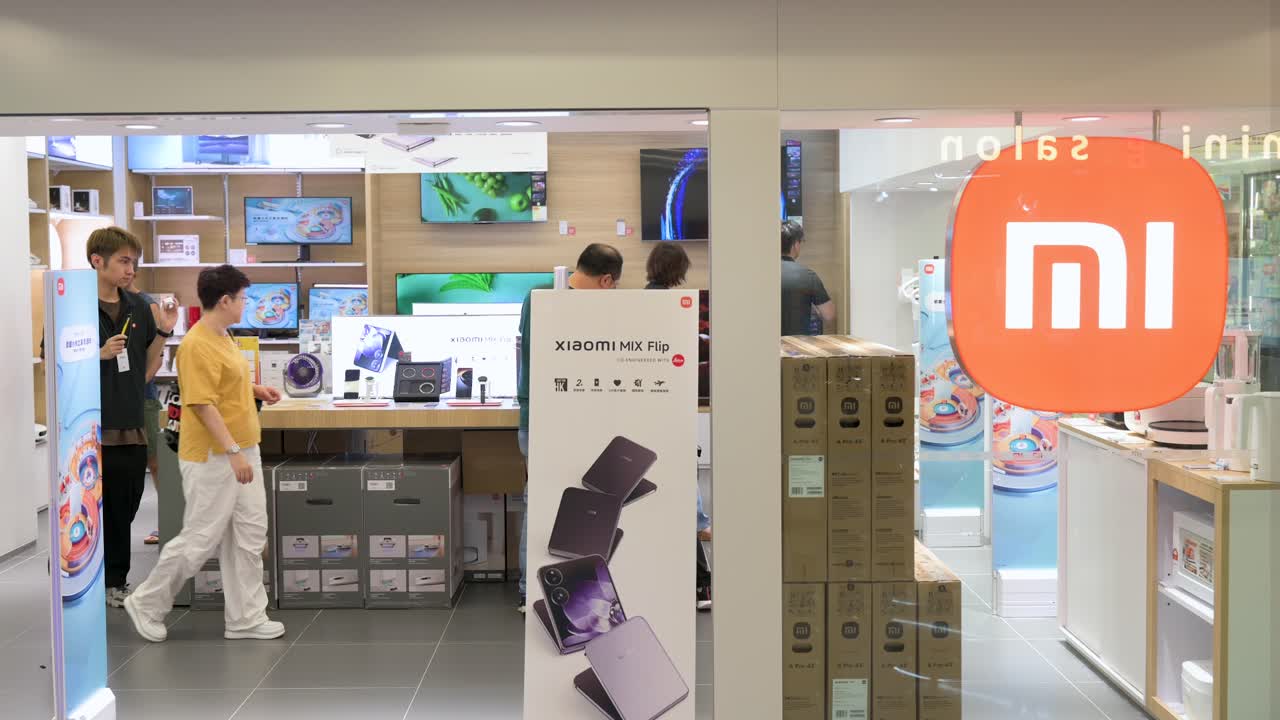 Customers are seen browsing at a Xiaomi flagship store, the Chinese multinational technology and electronics brand, in Hong Kong, China.