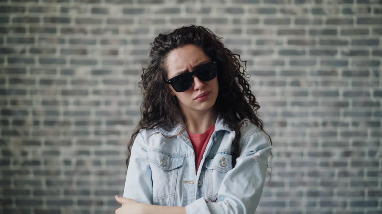 Woman with Sunglasses and a Questioning Expression