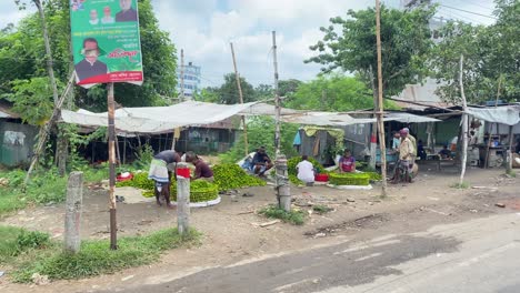 vendors selling spiny gourd at a local street market in narsingdi, bangladesh, south asia - pan right shot