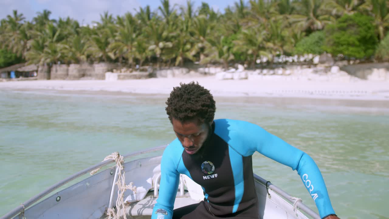 African Marine Conservationist Pulling Up Anchor Boat Before Scuba Dive In Mombasa Kenya, Africa