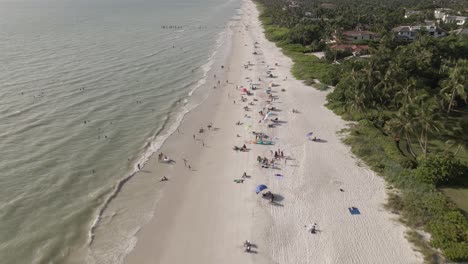 people enjoy white sandy ocean beach on sunny warm florida gulf coast