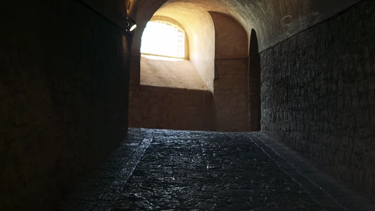Ancient stone alleyway with sunlight