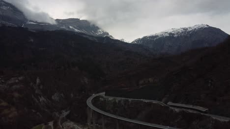 Drone-flight-over-the-Égratz-Viaduct,-a-curved-concrete-box-girder-bridge-in-the-French-Alps