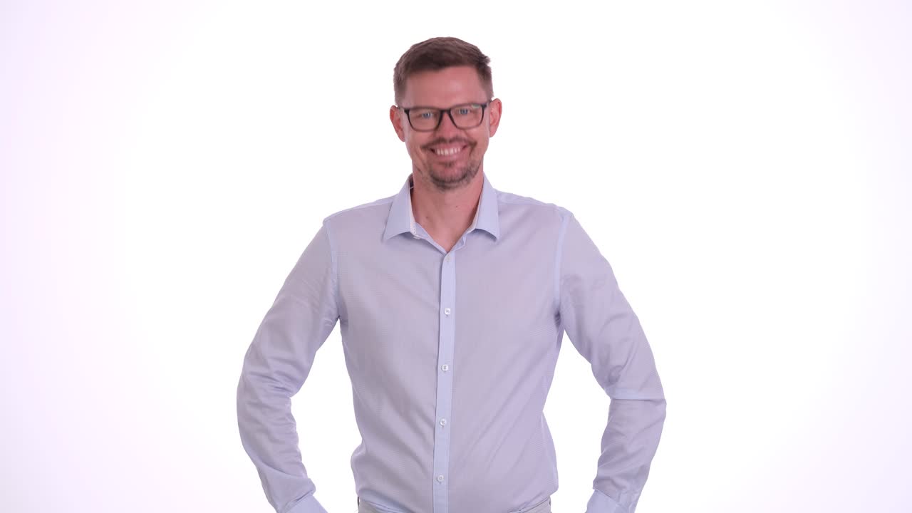 Portrait of a smiling man in a light blue shirt and glasses