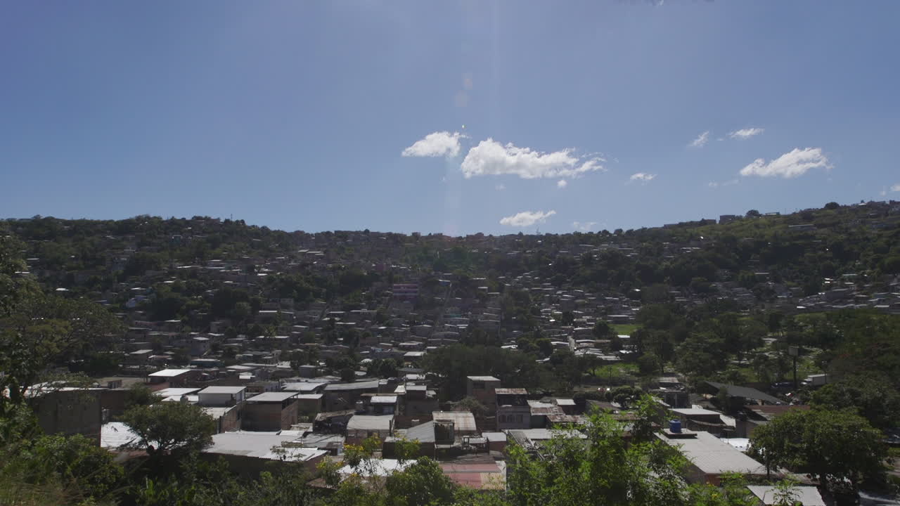 Establishing shot of Tegucigalpa, Honduras. Tilt down from the sun.